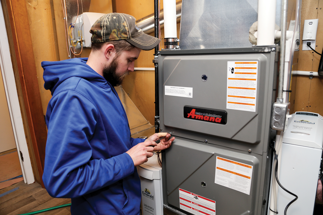 Technician Fastening Furnace Cover