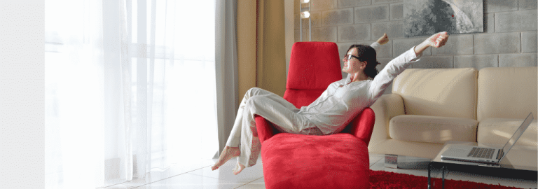 Woman relaxing on red chair after completed water softener services by PDM